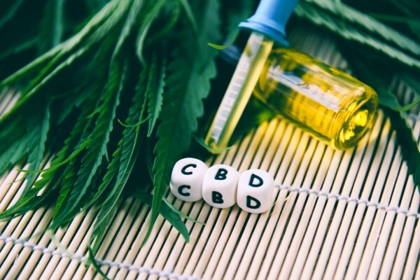 cannabis-oil-bottle-products-wooden-background-cbd-oil-cannabis-leaf-marijuana-leaves-hemp-medical-healthcare